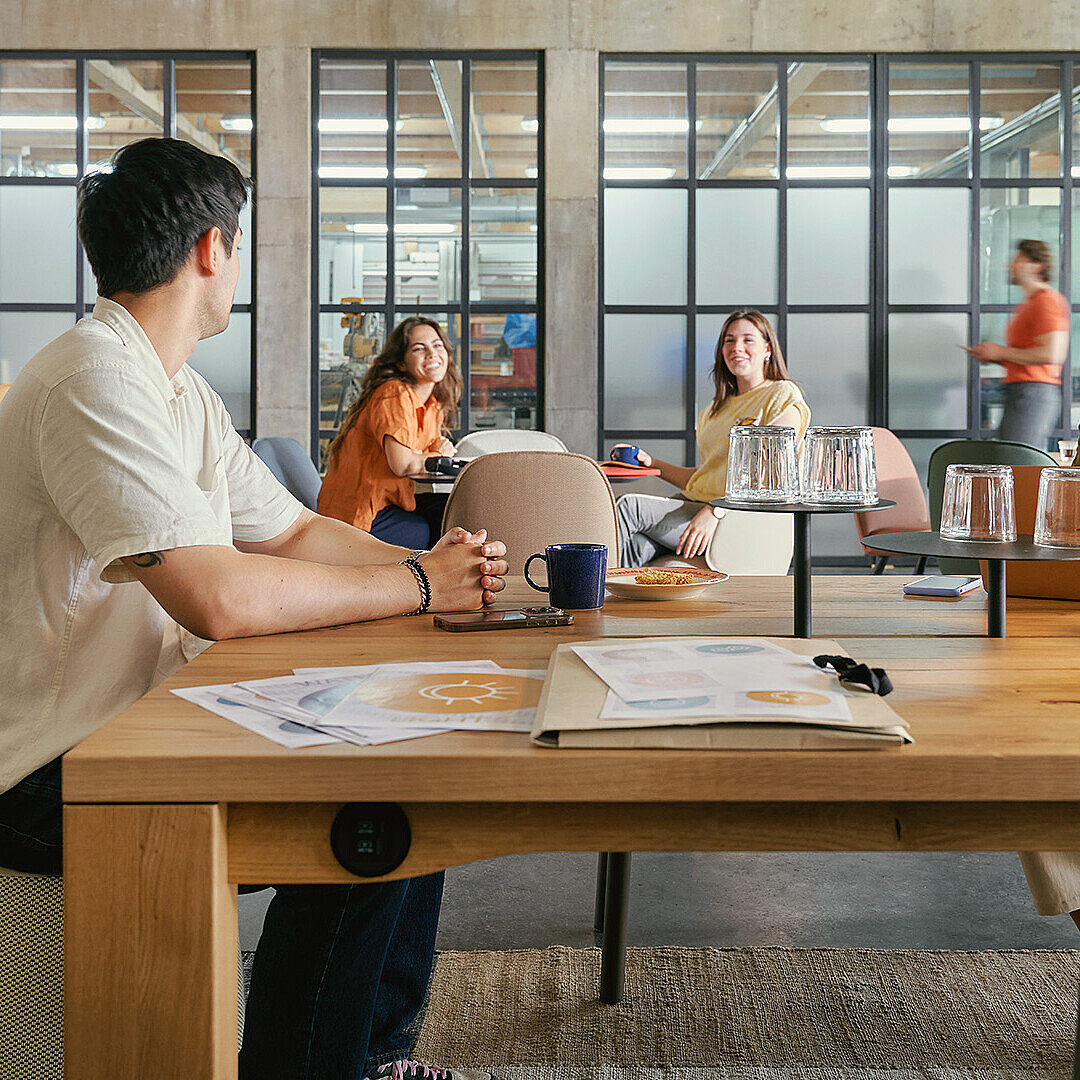 people working at the se:cafe team table